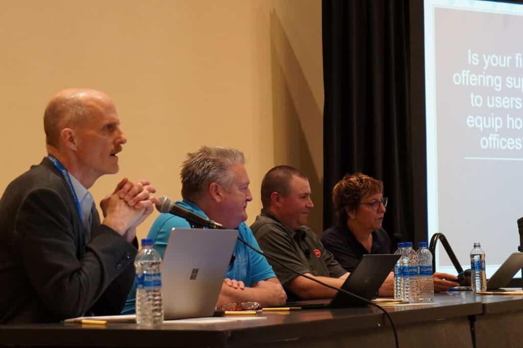 From left: Panelists Todd Corham, Jim McCue and Chris Hunt, and moderator TJ Johnson.